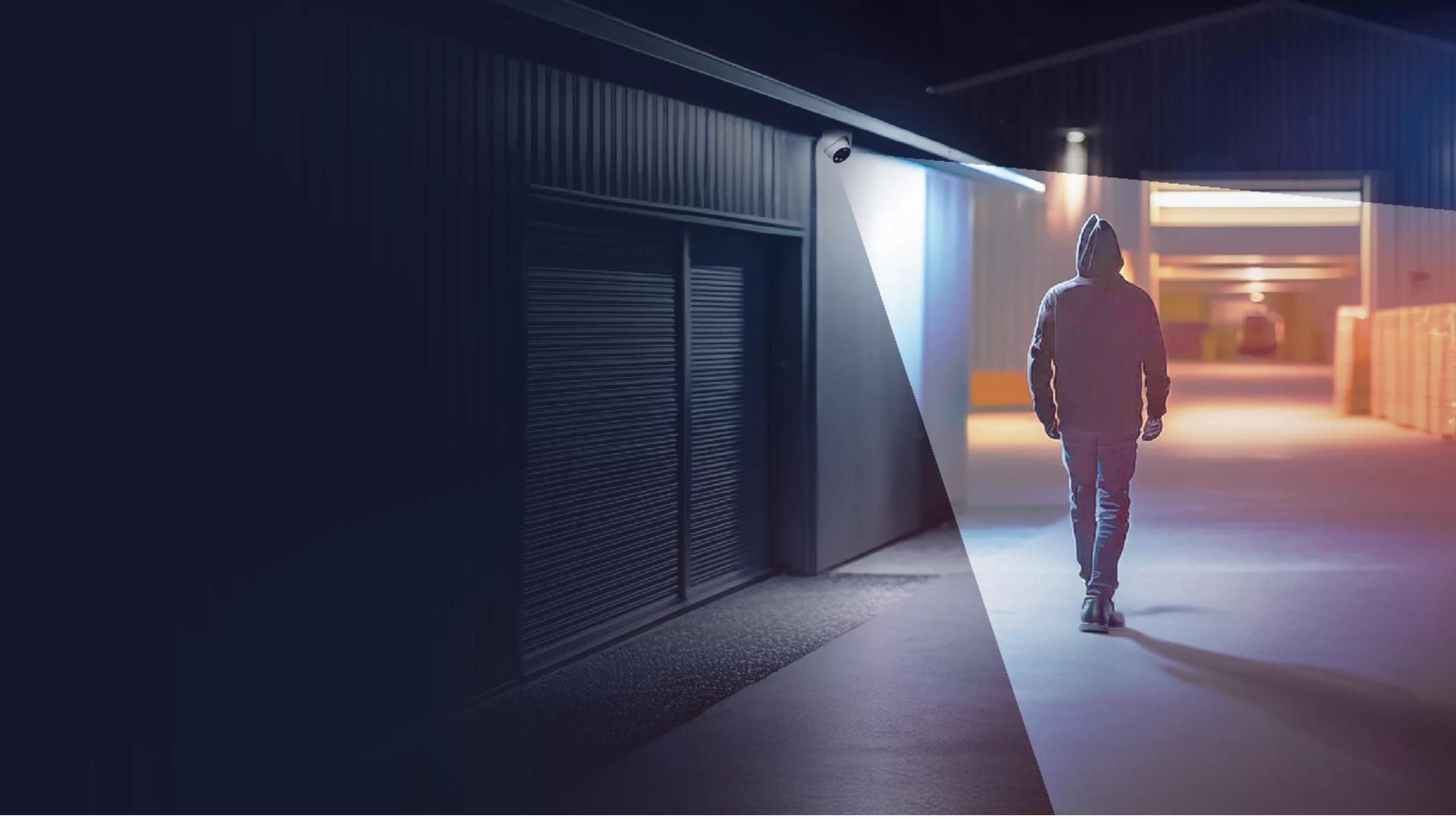 Man walking in a warehouse with a Dahua camera watching him